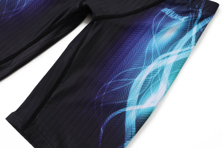 Close-up of 黑色男童泳褲 <68331022> featuring blue and purple abstract patterns with light streaks and feather-like designs on the side.