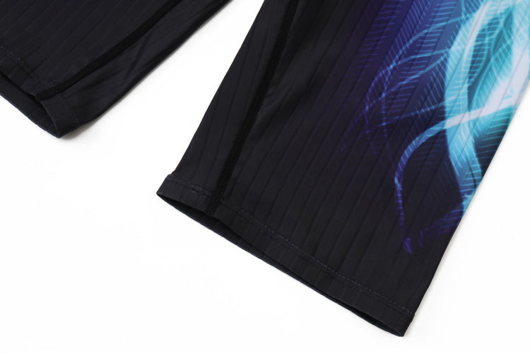 Close-up of the lower part of 黑色男童泳褲 <68331022> with vertical pinstripes and a blue abstract pattern on one side, laid flat on a white surface.