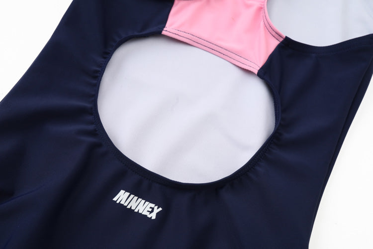 A close-up of the 寶藍色女童練習泳衣 <68400464-Y1> with a large back cutout, made from 彈性布料, and featuring the white MINNEX logo printed on the fabric.