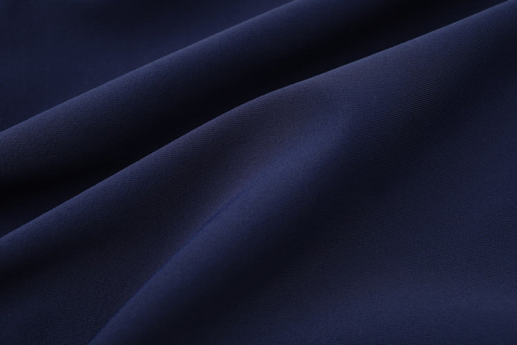 Close-up of smooth, dark blue 彈性布料 with soft folds and gentle shadows, highlighting the texture and rich color of the 寶藍色女童練習泳衣 <68400464-Y1>, ideal for girls' swim practice.