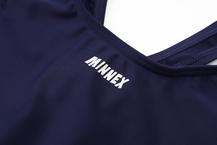 Close-up of the 深藍色女童練習泳衣 <68400616-D1> sports garment with MINNEX in bold white, featuring smooth, stretchy fabric and visible strap stitching—ideal for practice or swimming lessons.