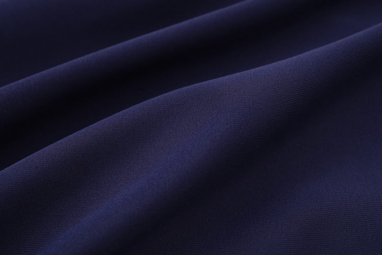 Close-up of smooth, dark navy blue fabric with gentle folds and soft texture—perfect for the 深藍色女童練習泳衣 <68400616-D1>, ideal for swimming lessons (游泳課專用).