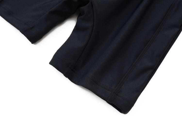 Close-up of the lower part of the 藍色女童練習泳衣 <68401830-H2> shorts, made from smooth, stretchy fabric, highlighting the hem and seams against a white background.