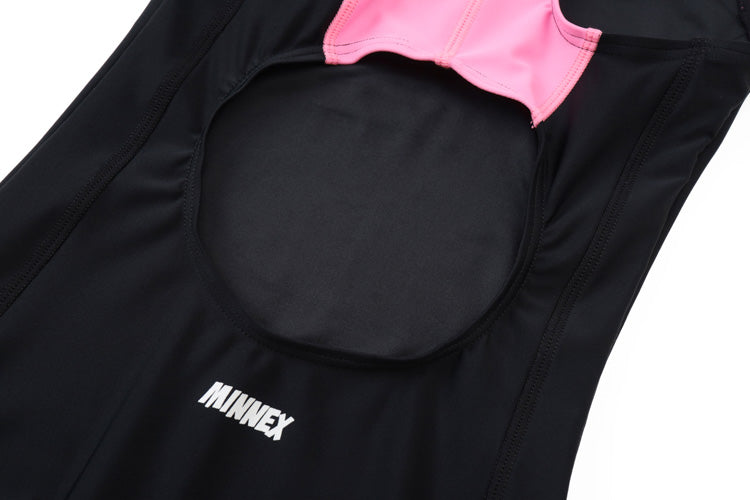 Close-up of a blue 藍色女童練習泳衣 <68401830-H2> with a large round cutout at the top and pink inner lining. The word MINNEX is printed in white on the fabric near the bottom of the cutout.