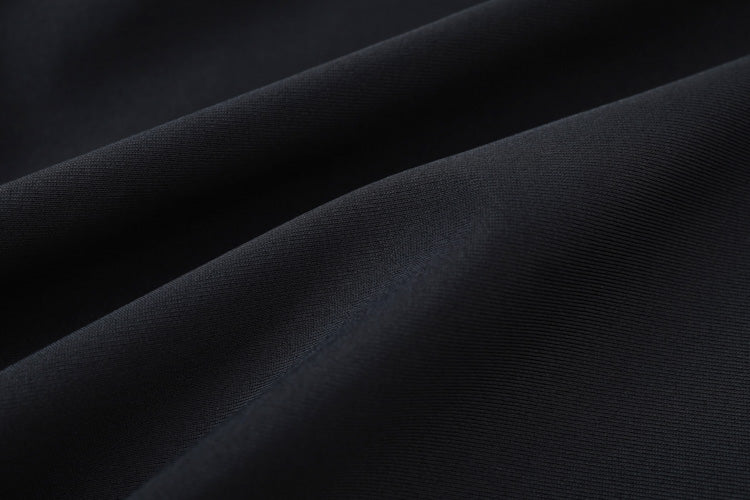 Close-up of smooth, dark fabric with gentle folds and subtle texture, creating soft shadows—ideal for 藍色女童練習泳衣 <68401830-H2> thanks to its comfortable and flexible quality.