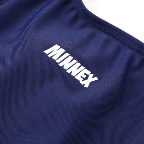 Close-up of the 深藍色女童練習泳衣 <68401830-H1> fabric, featuring bold white MINNEX lettering on navy blue elastic material.